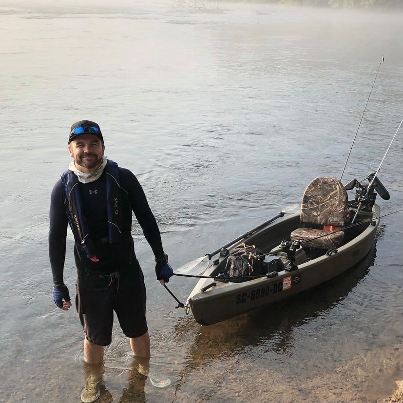 Angler with a fully-rigged Creek Boat on a misty river