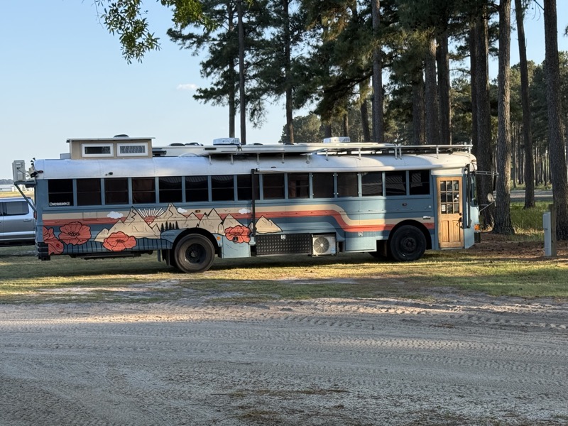 A converted school bus camper on site